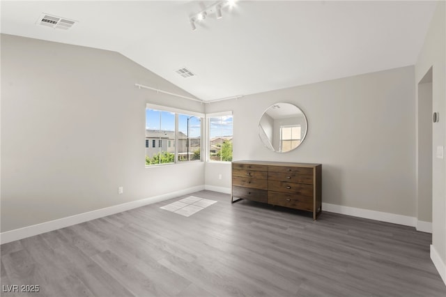 3058 Casarano Ct, Henderson, NV 89044 - unfurnished bedroom with lofted ceiling, wood finished floors, and rail lighting
