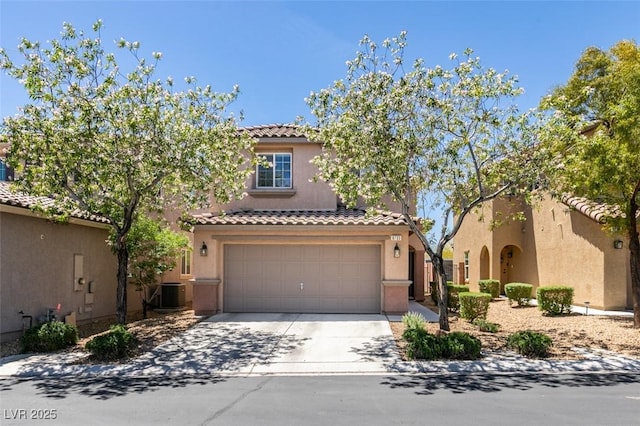 8733 Autumn Teal Ave, Las Vegas, NV 89178 - mediterranean / spanish home with a tile roof, an attached garage, stucco siding, and concrete driveway