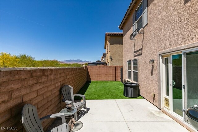 8733 Autumn Teal Ave, Las Vegas, NV 89178 - fenced backyard featuring a mountain view and a patio area