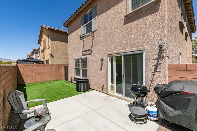 8733 Autumn Teal Ave, Las Vegas, NV 89178 - rear view of house with stucco siding, a fenced backyard, and a patio