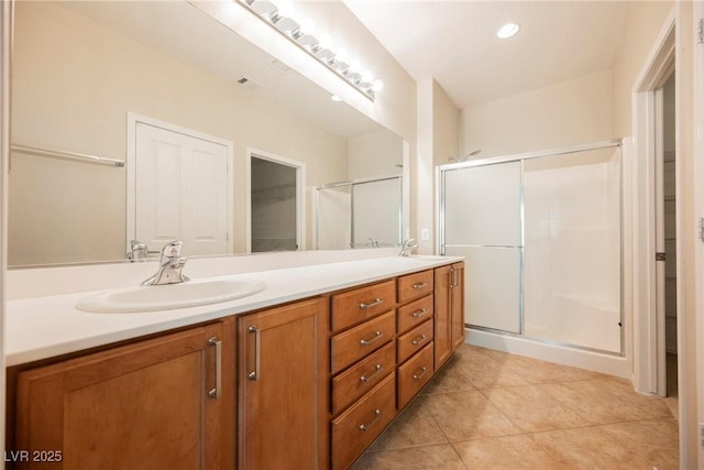 3405 Kingbird Dr, North Las Vegas, NV 89084 - full bath featuring double vanity, a spacious closet, a shower stall, tile patterned flooring, and recessed lighting