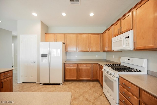 3405 Kingbird Dr, North Las Vegas, NV 89084 - kitchen featuring white appliances, light countertops, recessed lighting, and brown cabinetry