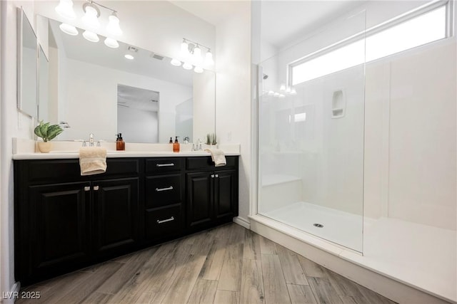 12426 Mosticone Way, Las Vegas, NV 89141 - bathroom with double vanity, an enclosed shower, and wood finished floors
