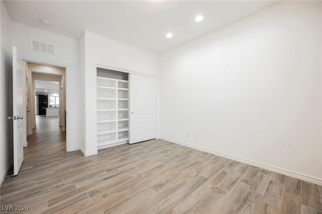 12426 Mosticone Way, Las Vegas, NV 89141 - unfurnished bedroom with light wood finished floors, a closet, and recessed lighting