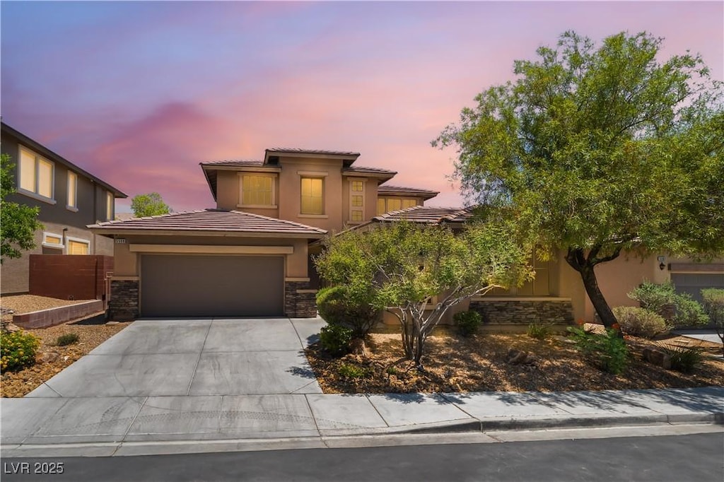 5568 Table Top Ln, Las Vegas, NV 89135 - view of front of property with a garage, driveway, stucco siding, and a tiled roof