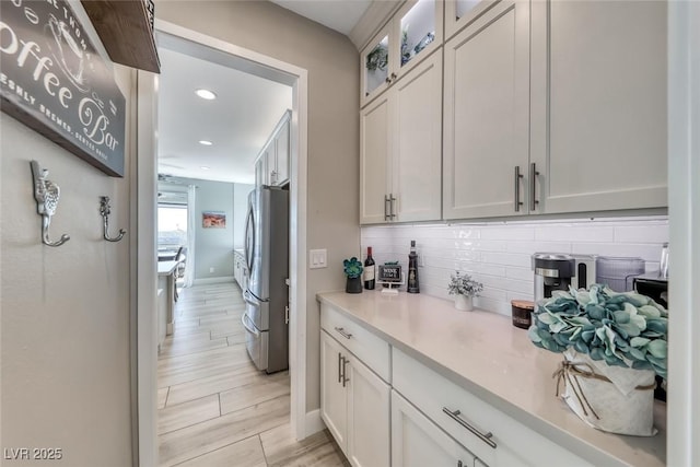 1523 Great Sands St, Boulder City, NV 89005 - kitchen with freestanding refrigerator, tasteful backsplash, light countertops, glass insert cabinets, and recessed lighting
