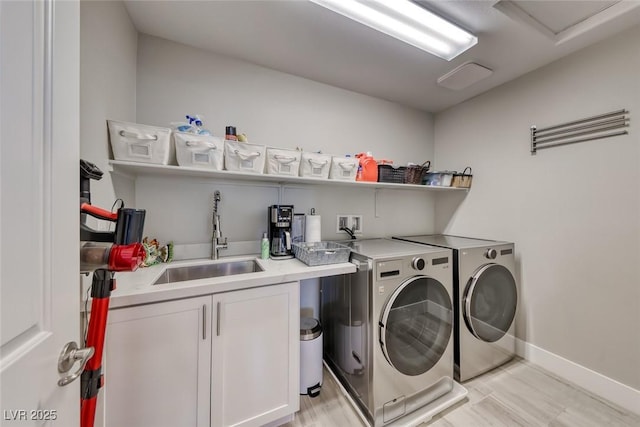 1523 Great Sands St, Boulder City, NV 89005 - washroom featuring washing machine and dryer, light wood-style flooring, and cabinet space