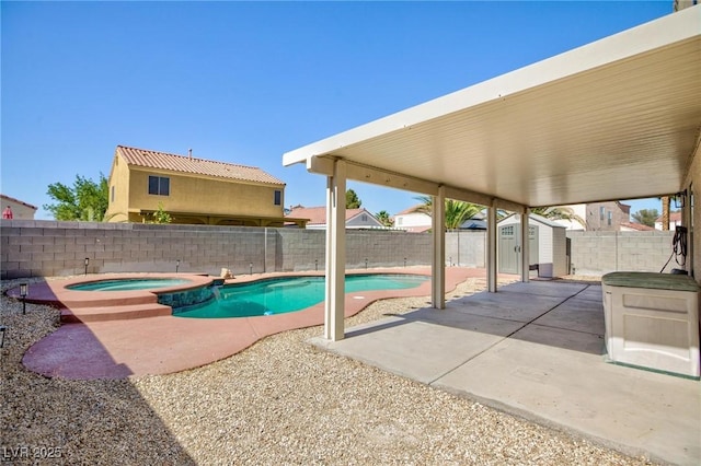 700 Red Bark Ln, Henderson, NV 89011 - view of swimming pool featuring a storage unit, a patio area, a fenced backyard, and a pool with connected hot tub
