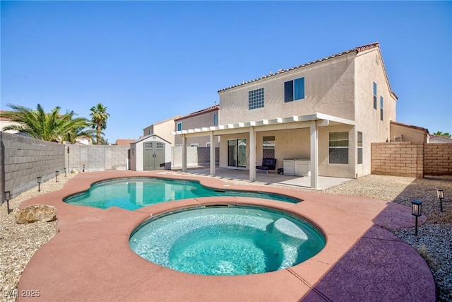 700 Red Bark Ln, Henderson, NV 89011 - view of swimming pool featuring a patio area, a storage shed, a fenced backyard, and a pool with connected hot tub