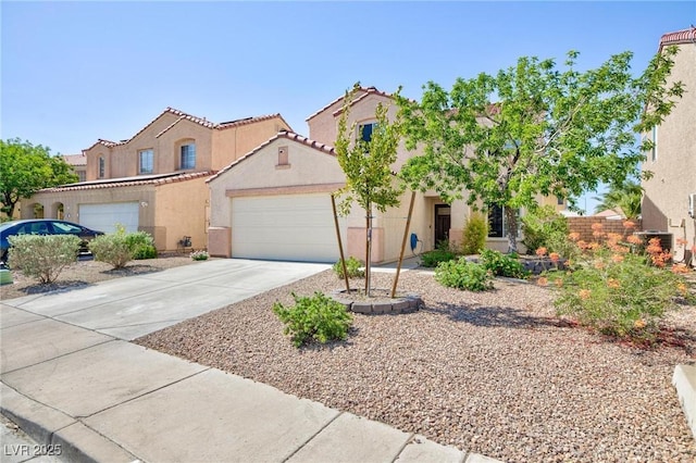 700 Red Bark Ln, Henderson, NV 89011 - mediterranean / spanish home featuring a garage, stucco siding, driveway, and a tiled roof