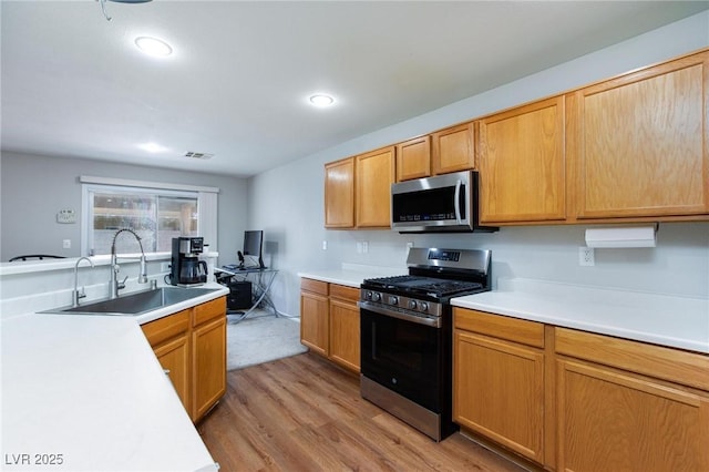 700 Red Bark Ln, Henderson, NV 89011 - kitchen with stainless steel appliances, light wood-style flooring, light countertops, and recessed lighting