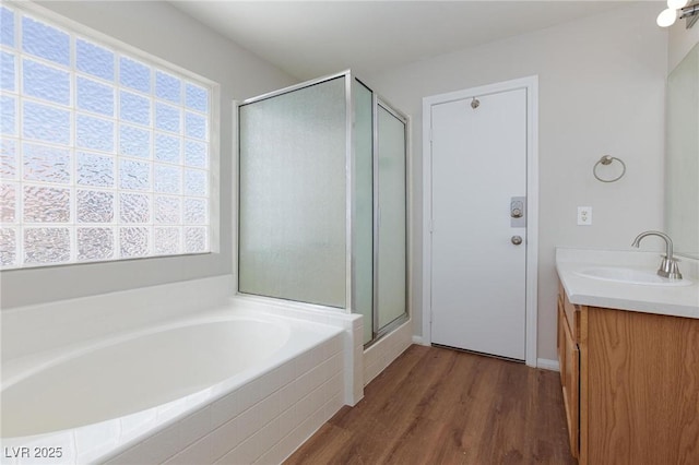 700 Red Bark Ln, Henderson, NV 89011 - full bathroom featuring a shower stall, vanity, a garden tub, and wood finished floors