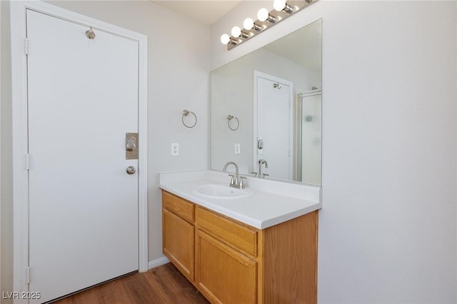 700 Red Bark Ln, Henderson, NV 89011 - bathroom featuring vanity, wood finished floors, and a shower with door