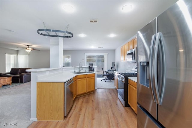 700 Red Bark Ln, Henderson, NV 89011 - kitchen featuring appliances with stainless steel finishes, open floor plan, healthy amount of natural light, light countertops, and recessed lighting