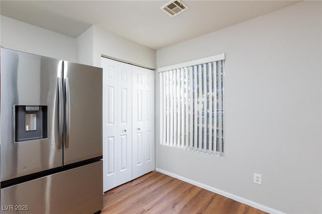 700 Red Bark Ln, Henderson, NV 89011 - kitchen with stainless steel fridge with ice dispenser and light wood-type flooring