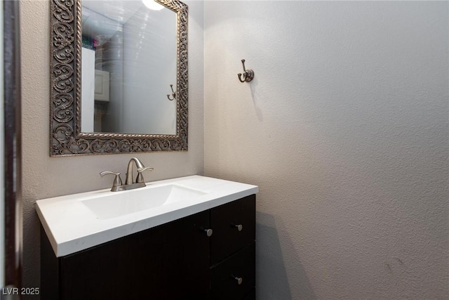 700 Red Bark Ln, Henderson, NV 89011 - bathroom with vanity and a textured wall