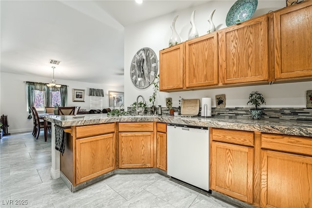 3495 Eagle Bend St, Las Vegas, NV 89122 - kitchen with dishwasher, a peninsula, a chandelier, hanging light fixtures, and brown cabinets