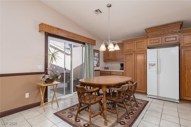 8213 Cabin Springs Ave, Las Vegas, NV 89131 - dining room featuring vaulted ceiling, light tile patterned floors, and a chandelier