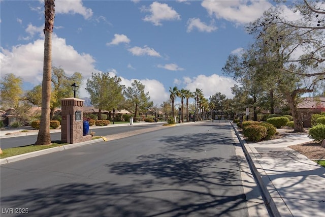 8213 Cabin Springs Ave, Las Vegas, NV 89131 - view of asphalt street with curbs, street lights, and sidewalks