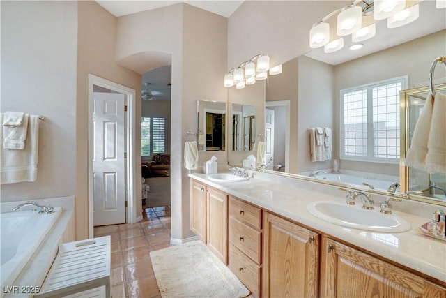 10320 Luxembourg Ave, Las Vegas, NV 89145 - ensuite bathroom featuring a bath, tile patterned flooring, double vanity, and a ceiling fan