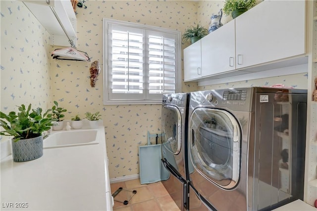 10320 Luxembourg Ave, Las Vegas, NV 89145 - washroom featuring wallpapered walls, washer and dryer, cabinet space, and light tile patterned flooring