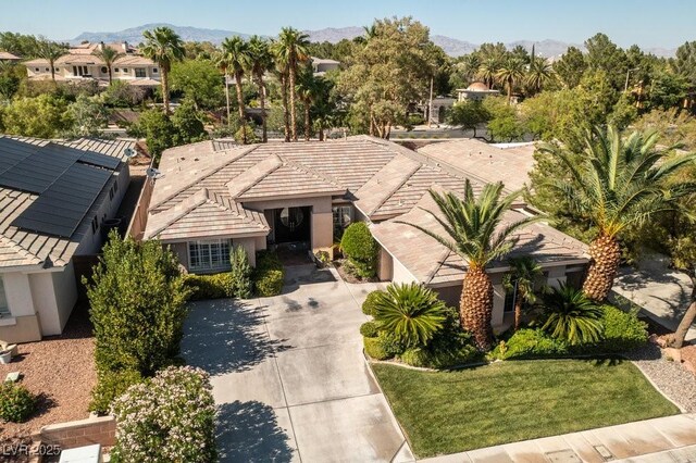 10320 Luxembourg Ave, Las Vegas, NV 89145 - view of front facade with a mountain view, driveway, and stucco siding