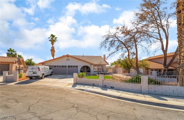 327 Fuente Dr, Henderson, NV 89014 - mediterranean / spanish-style house featuring a fenced front yard, a garage, concrete driveway, stucco siding, and a tile roof