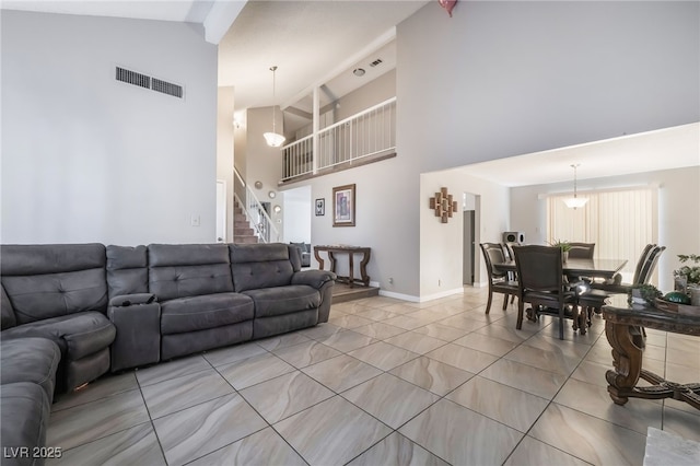 327 Fuente Dr, Henderson, NV 89014 - living room featuring high vaulted ceiling, stairs, and light tile patterned floors