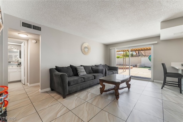 327 Fuente Dr, Henderson, NV 89014 - living room with light tile patterned floors and a textured ceiling
