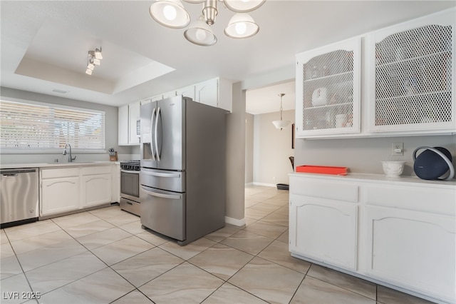 327 Fuente Dr, Henderson, NV 89014 - kitchen with stainless steel appliances, white cabinets, light countertops, and light tile patterned flooring