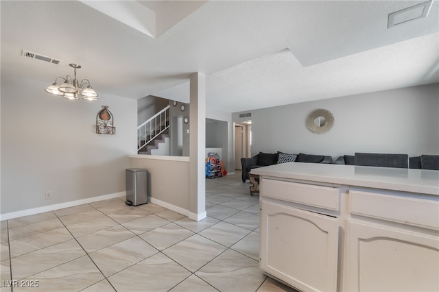 327 Fuente Dr, Henderson, NV 89014 - kitchen featuring open floor plan, light countertops, light tile patterned floors, decorative light fixtures, and a chandelier