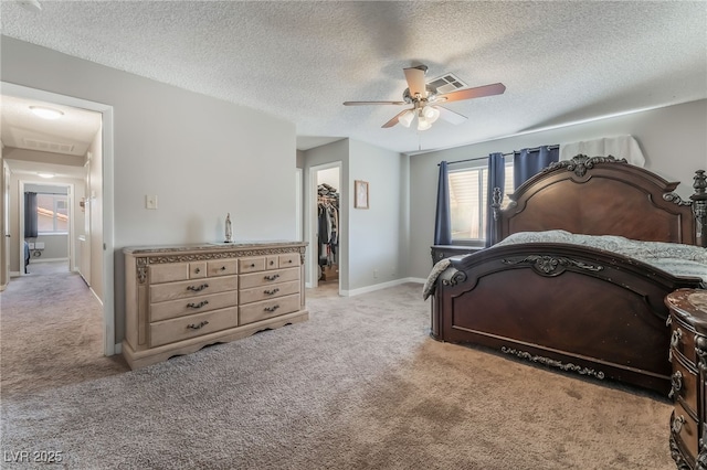 327 Fuente Dr, Henderson, NV 89014 - bedroom featuring light carpet, a walk in closet, a textured ceiling, ceiling fan, and a closet