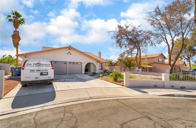 327 Fuente Dr, Henderson, NV 89014 - mediterranean / spanish-style home featuring a chimney, a fenced front yard, a garage, a tile roof, and concrete driveway