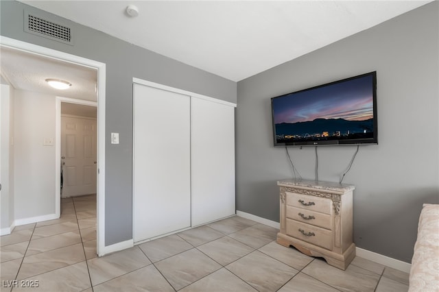 327 Fuente Dr, Henderson, NV 89014 - bedroom featuring a closet and light tile patterned flooring