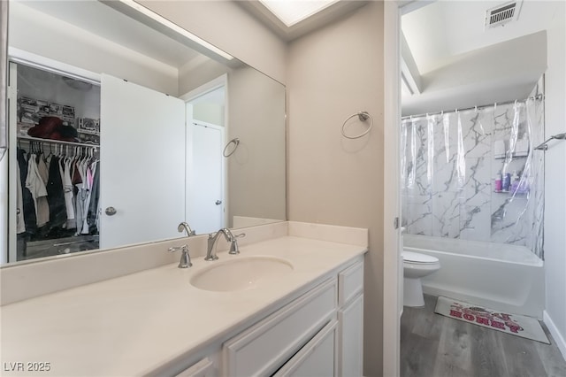 327 Fuente Dr, Henderson, NV 89014 - bathroom with vanity, wood finished floors, shower / tub combo, and a walk in closet