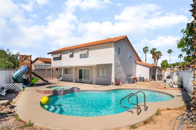 327 Fuente Dr, Henderson, NV 89014 - view of swimming pool featuring a fenced backyard, a patio, a pool with connected hot tub, and a playground