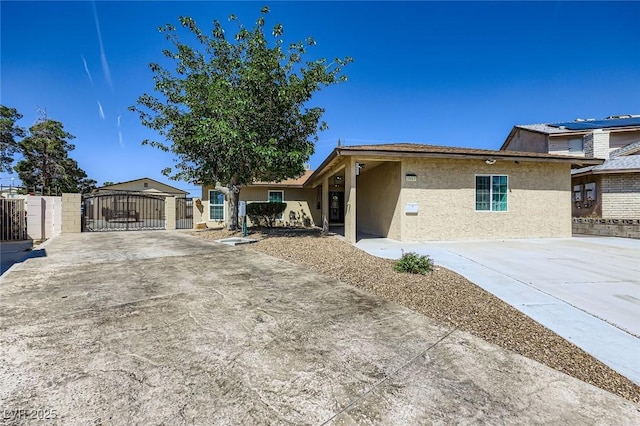 3557 Wayne Cir, Las Vegas, NV 89121 - view of front of house with a gate, stucco siding, and concrete driveway