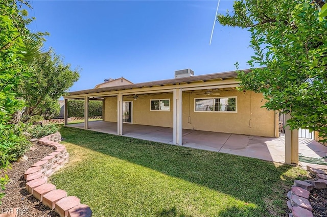 3557 Wayne Cir, Las Vegas, NV 89121 - back of property with ceiling fan, stucco siding, a yard, and a patio area