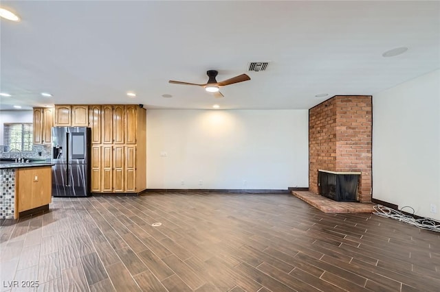 3557 Wayne Cir, Las Vegas, NV 89121 - unfurnished living room with ceiling fan, dark wood-style floors, a fireplace, and recessed lighting