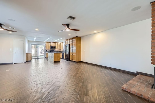 3557 Wayne Cir, Las Vegas, NV 89121 - unfurnished living room with ceiling fan, recessed lighting, and dark wood finished floors