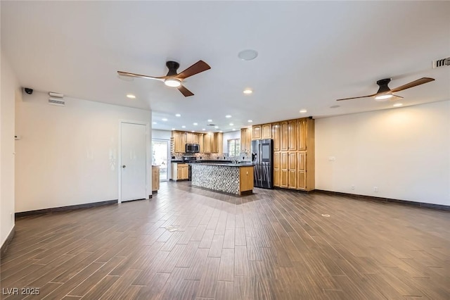 3557 Wayne Cir, Las Vegas, NV 89121 - kitchen featuring a ceiling fan, stainless steel microwave, fridge with ice dispenser, dark countertops, and recessed lighting
