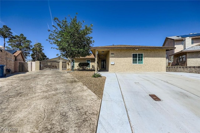 3557 Wayne Cir, Las Vegas, NV 89121 - view of front facade featuring a gate, stucco siding, and driveway