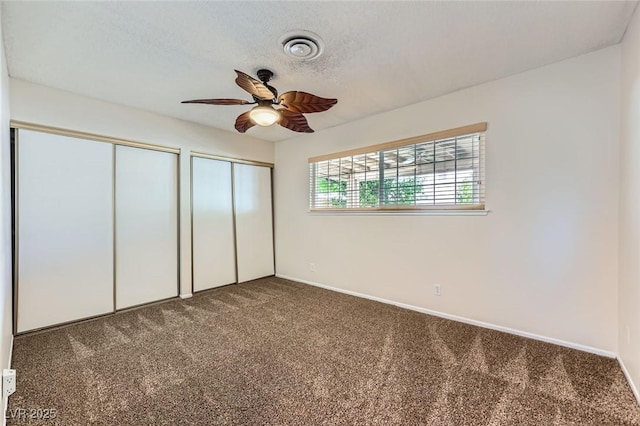 3557 Wayne Cir, Las Vegas, NV 89121 - unfurnished bedroom featuring carpet flooring, multiple closets, a textured ceiling, and a ceiling fan
