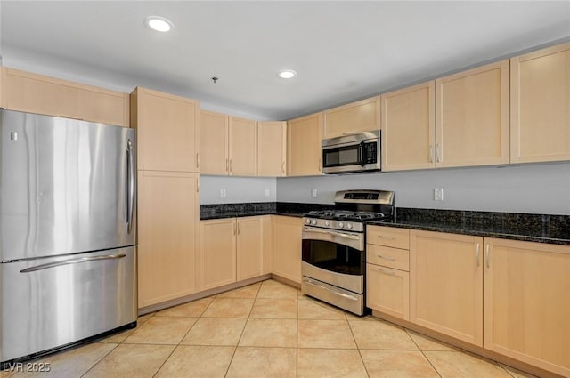 150 Las Vegas Blvd Unit 1716, Las Vegas, NV 89101 - kitchen featuring appliances with stainless steel finishes, light brown cabinets, light tile patterned floors, dark stone countertops, and recessed lighting