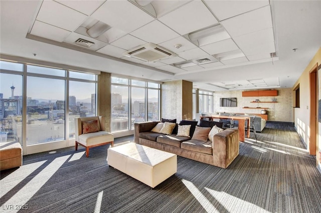 150 Las Vegas Blvd Unit 1716, Las Vegas, NV 89101 - living room featuring dark colored carpet, a view of city, and a drop ceiling
