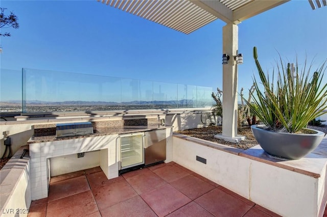 150 Las Vegas Blvd Unit 1716, Las Vegas, NV 89101 - view of patio / terrace with wine cooler, exterior kitchen, and a mountain view