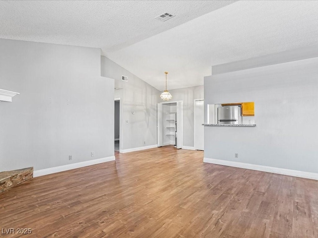 5861 Medallion Dr Unit 202, Las Vegas, NV 89122 - unfurnished living room with vaulted ceiling and wood finished floors