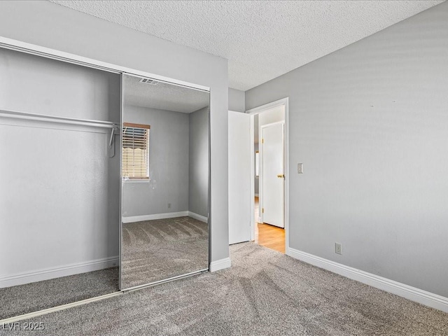 5861 Medallion Dr Unit 202, Las Vegas, NV 89122 - unfurnished bedroom with carpet, a closet, and a textured ceiling