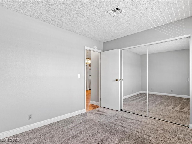 5861 Medallion Dr Unit 202, Las Vegas, NV 89122 - unfurnished bedroom featuring carpet, a textured ceiling, and a closet