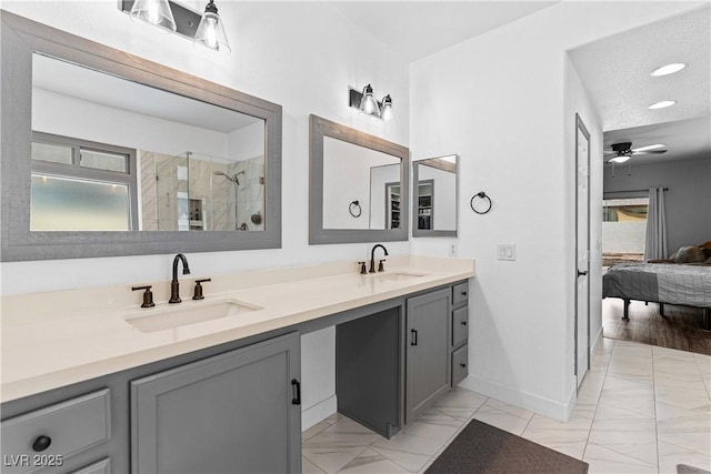 4212 Helens Pouroff Ave, North Las Vegas, NV 89085 - ensuite bathroom featuring marble look tiles, double vanity, a tile shower, a ceiling fan, and recessed lighting
